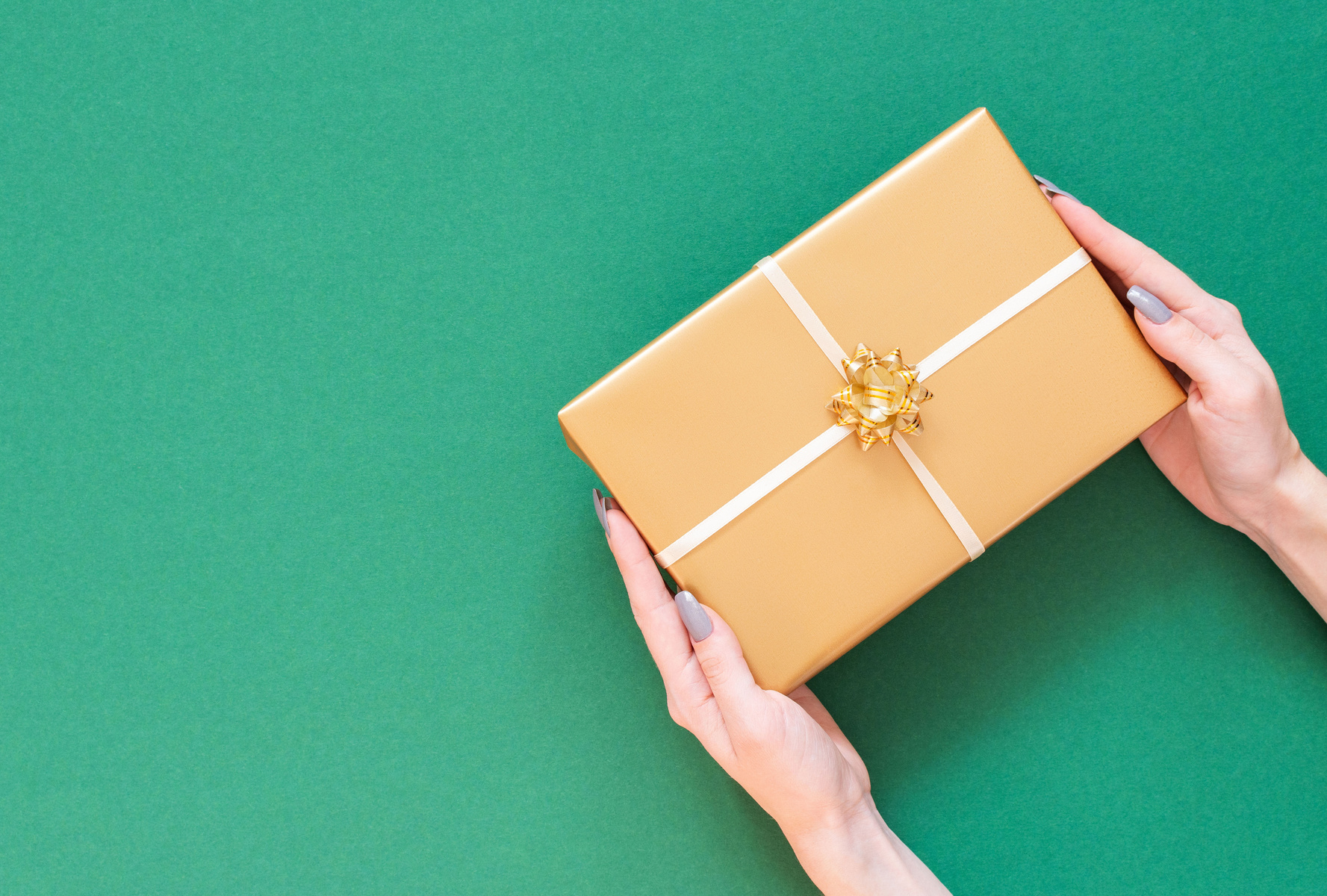 Female Hands Holding a Gift Box